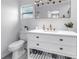 Bright bathroom featuring a vanity with gold hardware, a large mirror, and a clean design at 4432 W Mccoy St, Tampa, FL 33616