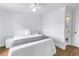 Bright bedroom with a ceiling fan, light wood floors, and an ensuite bathroom at 4432 W Mccoy St, Tampa, FL 33616