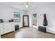 Bright bedroom with a ceiling fan, mirror, and a door leading to the outside at 4432 W Mccoy St, Tampa, FL 33616