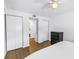 Simple bedroom with white walls, closets, dresser, and wood floors at 4432 W Mccoy St, Tampa, FL 33616