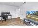 Bright bedroom featuring a mounted television and wood laminate flooring at 4432 W Mccoy St, Tampa, FL 33616
