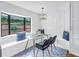 Charming breakfast nook with modern decor, bench seating, a view outside and geometric accent wall at 4432 W Mccoy St, Tampa, FL 33616