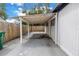 Spacious carport area next to the home's exterior and a wooden fence at 4432 W Mccoy St, Tampa, FL 33616