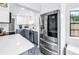 Bright, modern kitchen with stainless steel appliances, quartz counters, and blue and white patterned tile flooring at 4432 W Mccoy St, Tampa, FL 33616