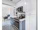 Contemporary kitchen with stainless steel appliances, ample counter space, and a view to a quaint breakfast nook at 4432 W Mccoy St, Tampa, FL 33616