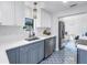 Updated kitchen with stainless appliances, white cabinets, a modern sink, and unique patterned tile flooring at 4432 W Mccoy St, Tampa, FL 33616