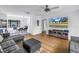 Open floor plan, living room with TV and kitchen/dining area featuring light wood floors at 4432 W Mccoy St, Tampa, FL 33616