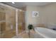Modern bathroom featuring a tiled shower, a separate soaking tub, and neutral-toned walls at 449 S 12Th St # 2205, Tampa, FL 33602