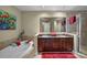 Elegant bathroom with double sink vanity, soaking tub, and glass-enclosed shower for a spa-like experience at 449 S 12Th St # 2205, Tampa, FL 33602