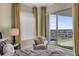 Inviting bedroom with a plush bed, cityscape views, and a cozy chair in a sunlit corner at 449 S 12Th St # 2205, Tampa, FL 33602