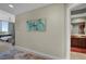 Elegant hallway leading to a bedroom and bathroom, accentuated with tasteful art and neutral colors at 449 S 12Th St # 2205, Tampa, FL 33602