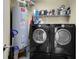Convenient laundry room with washer, dryer, and storage shelving for supplies at 449 S 12Th St # 2205, Tampa, FL 33602