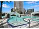 Beautiful swimming pool featuring bridge, hot tub, and surrounding high-rise condos under a blue sky at 449 S 12Th St # 2205, Tampa, FL 33602