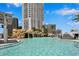 Luxurious pool with rock waterfall feature and towering building backdrop under a clear blue sky at 449 S 12Th St # 2205, Tampa, FL 33602