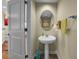 Clean powder room featuring a pedestal sink, an oval mirror, and neutral-toned walls at 449 S 12Th St # 2205, Tampa, FL 33602