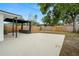 Open backyard patio space with a pergola and wooden fence at 4681 70Th N Ave, Pinellas Park, FL 33781