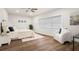 Bright bedroom features a comfortable bed, soft textures, and a large window at 4681 70Th N Ave, Pinellas Park, FL 33781