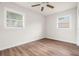 Bedroom with two windows and wood-look flooring at 4681 70Th N Ave, Pinellas Park, FL 33781