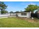 Inviting single-story home with a covered parking, manicured landscaping, and a well-maintained green lawn at 4681 70Th N Ave, Pinellas Park, FL 33781