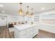 Open kitchen showcasing an island with seating, stainless steel appliances, and view to the living room at 4681 70Th N Ave, Pinellas Park, FL 33781