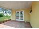 Cozy covered patio area with brick flooring, offering a relaxing outdoor space at 5033 Tammy Ln, Holiday, FL 34690