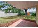 A fenced in backyard with mature tree, providing ample space for outdoor activities and relaxation at 5033 Tammy Ln, Holiday, FL 34690