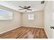 Bedroom boasts a ceiling fan, hard surface floors, and a window with natural light at 5033 Tammy Ln, Holiday, FL 34690
