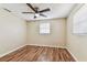 An inviting bedroom featuring ample natural light and a contemporary ceiling fan at 5033 Tammy Ln, Holiday, FL 34690