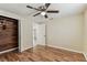 A cozy bedroom with ceiling fan, a closet with wood accents, and ample natural light at 5033 Tammy Ln, Holiday, FL 34690