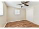 Bedroom featuring hardwood floors, a ceiling fan, and a built-in closet at 5033 Tammy Ln, Holiday, FL 34690