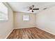 Comfortable bedroom featuring hardwood floors and two windows with white trim at 5033 Tammy Ln, Holiday, FL 34690