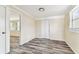 Bedroom with hard surface floors and two windows, complemented by neutral walls and white doors at 5033 Tammy Ln, Holiday, FL 34690
