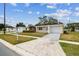 Single-story home with lawn, trees, and a driveway, showcasing a simple, suburban aesthetic at 5033 Tammy Ln, Holiday, FL 34690