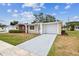 Charming single-story home with a well-manicured lawn, brick accents, and an attached garage at 5033 Tammy Ln, Holiday, FL 34690
