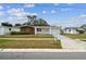 Inviting single-story home with a front yard, brick and siding, and a paved driveway at 5033 Tammy Ln, Holiday, FL 34690
