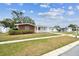 Inviting single-story home with a front yard, brick and siding, and a paved driveway at 5033 Tammy Ln, Holiday, FL 34690