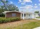 Charming single-story home featuring a blend of brick and stucco exterior with an attached garage at 5033 Tammy Ln, Holiday, FL 34690
