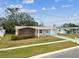 Quaint single-Gathering home with a well-kept lawn, attached garage, and appealing exterior design at 5033 Tammy Ln, Holiday, FL 34690