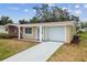 Well-maintained home featuring a garage, manicured lawn and inviting curb appeal on a clear day at 5033 Tammy Ln, Holiday, FL 34690