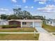 Inviting home with manicured lawn, attached garage, and lovely street presence in a peaceful neighborhood at 5033 Tammy Ln, Holiday, FL 34690