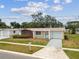 Charming single-story home with a well-manicured lawn, mature landscaping, and a private driveway at 5033 Tammy Ln, Holiday, FL 34690