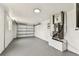 The utility area of the garage featuring clean epoxy floors and efficient HVAC system at 5033 Tammy Ln, Holiday, FL 34690