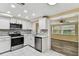 Bright kitchen features white cabinets, stainless steel appliances, and a mosaic tile backsplash at 5033 Tammy Ln, Holiday, FL 34690