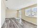 Inviting living room with wood-look flooring and a sunny front entrance at 5033 Tammy Ln, Holiday, FL 34690