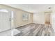 Open living room featuring hardwood floors, a large window, and ample natural light at 5033 Tammy Ln, Holiday, FL 34690