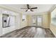 This living room boasts wood-look flooring, a ceiling fan, and ample natural light at 5033 Tammy Ln, Holiday, FL 34690