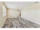 Spacious living room featuring stylish wood-look floors and neutral wall paint, ready for personalization at 5033 Tammy Ln, Holiday, FL 34690