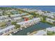 Aerial view of waterfront community, showcasing docks, waterways, and nearby tennis courts at 5037 Starfish Se Dr # A, St Petersburg, FL 33705