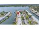 Aerial view showing a highlighted townhome with waterfront access, a marina, and ample parking at 5037 Starfish Se Dr # A, St Petersburg, FL 33705