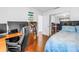 Well-lit bedroom with hardwood floors, offering a functional workspace and comfortable sleeping area at 5037 Starfish Se Dr # A, St Petersburg, FL 33705